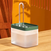 Transparent Modern Pet Water Fountain with green lid on a wooden surface against an orange wall
