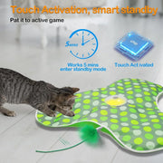 Cat playing with a green and white polka dot Hide and Seek Interactive Cat Toy Blanket with a chip and clock illustration.