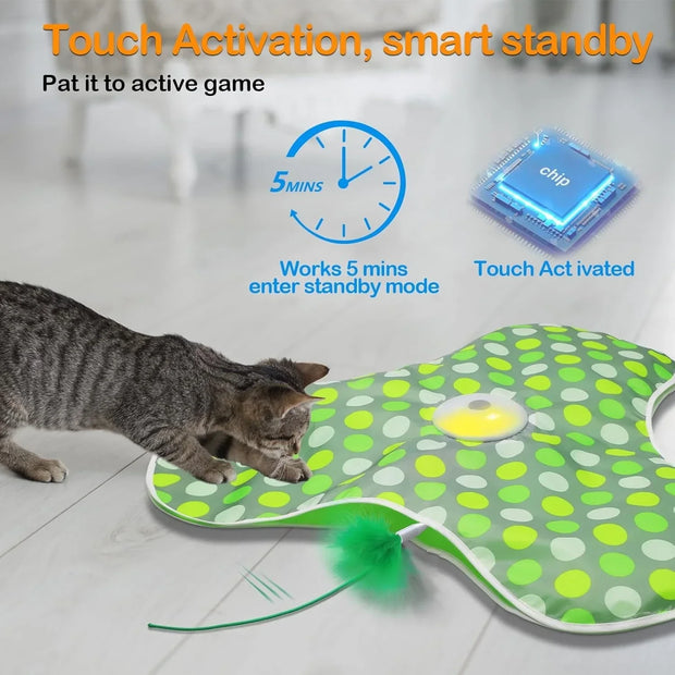 Cat playing with a green and white polka dot Hide and Seek Interactive Cat Toy Blanket with a chip and clock illustration.