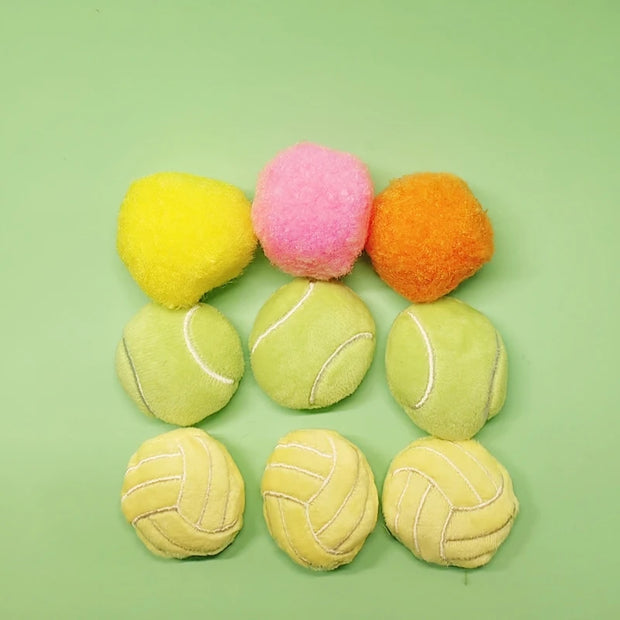 Colorful Soft Plush Pet Sports Balls Toy Set including pom-poms and tennis balls on a green background