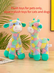 Two colorful alpaca Plush Giraffe Dog Toy on a wooden surface with a blurred green leafy background.