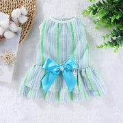 Summer Princess Dress with green and white stripes and a blue bow on a textured surface.