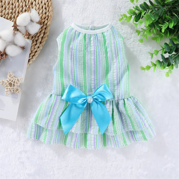 Summer Princess Dress with green and white stripes and a blue bow on a textured surface.