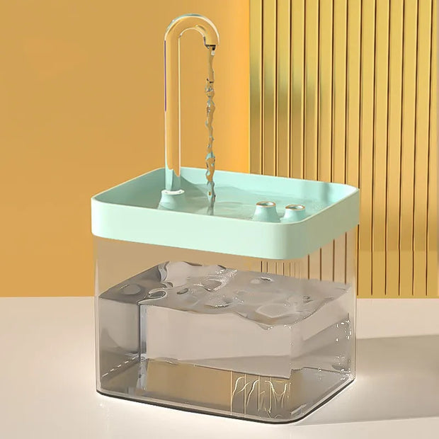 Portable Modern Pet Water Fountain sink with clear base and green top against a yellow wall.