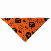 Halloween Pet Hat And Drool Towel Set with pumpkins, bats, and spider webs on an orange background.