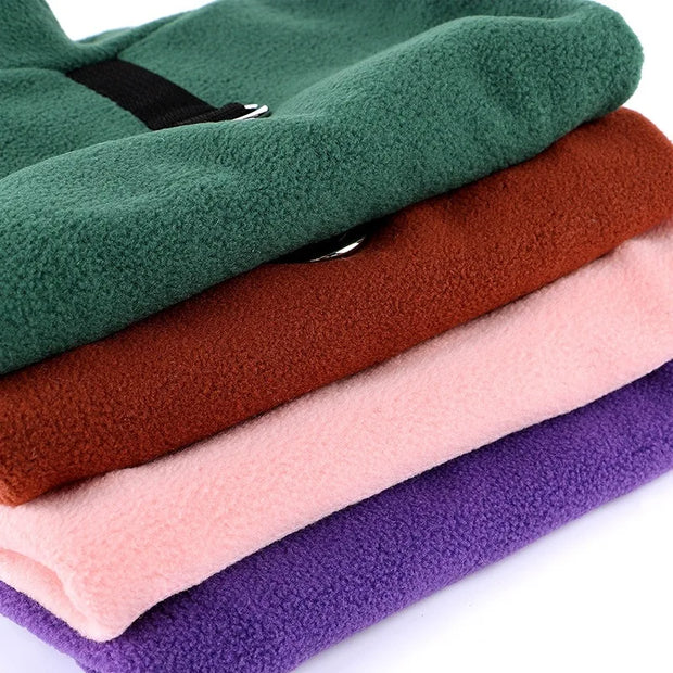 Stack of folded Fleece Dog Jacket fabric in green, brown, pink, and purple on a white background