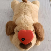 Heartbeat Plush Dog Toy with a red heart-shaped nose on a light wooden floor.