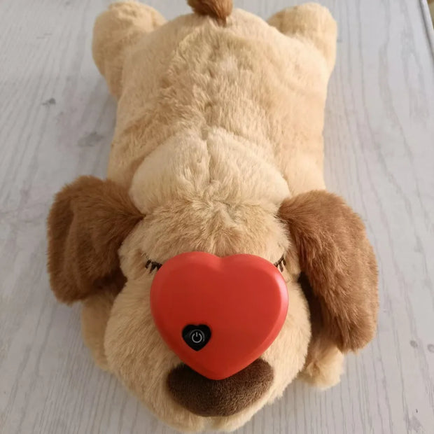 Heartbeat Plush Dog Toy with a red heart-shaped nose on a light wooden floor.
