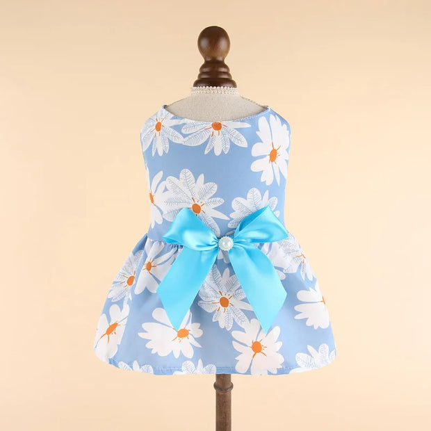 Summer Princess Dress with floral pattern and blue bow on a mannequin against a beige background