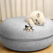 Gray Felt Cat Cave Bed cat-shaped ottoman with a kitten on top, against a neutral background