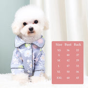 Small white dog wearing a floral hooded Elegant Pet Shirt with a size chart on a light background