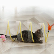 Cat playing with a transparent Interactive Spiral Cat Toy Spring Tunnel with Plush Mouse on a light wooden floor.