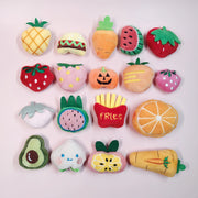 Collection of colorful Soft Plush Pet Sports Balls Toy Set shaped like fruits, vegetables, and a burger on a light pink background.