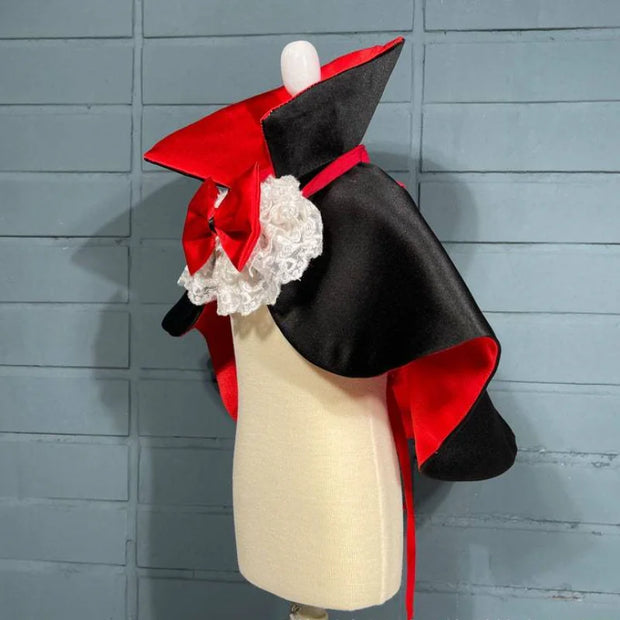 Black and red Vampire Pet Costume on a mannequin against a gray wooden panel background