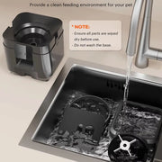 Smart Automatic Pet Feeder with WiFi Control station being rinsed under running water in a sink with a note on cleaning instructions.
